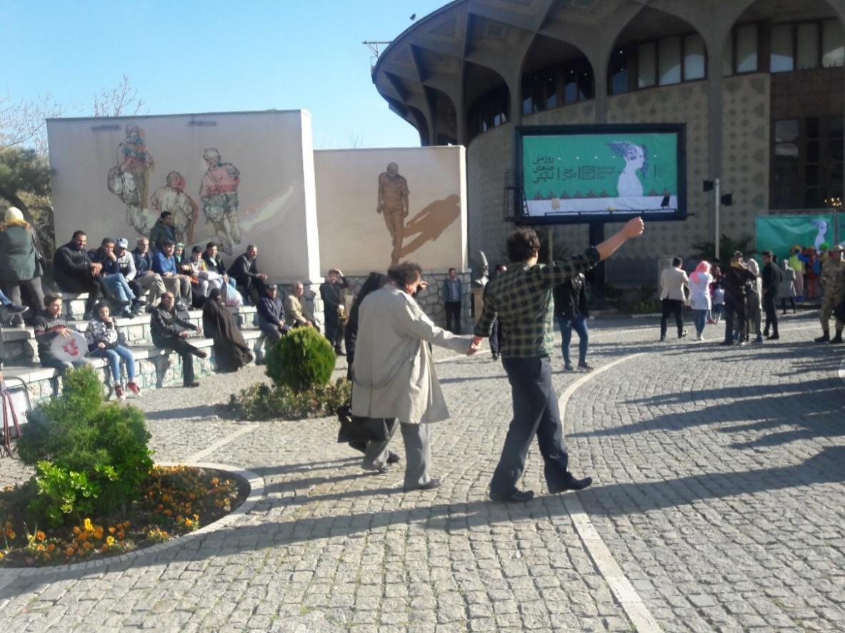 A group of people walking in a courtyard

Description automatically generated