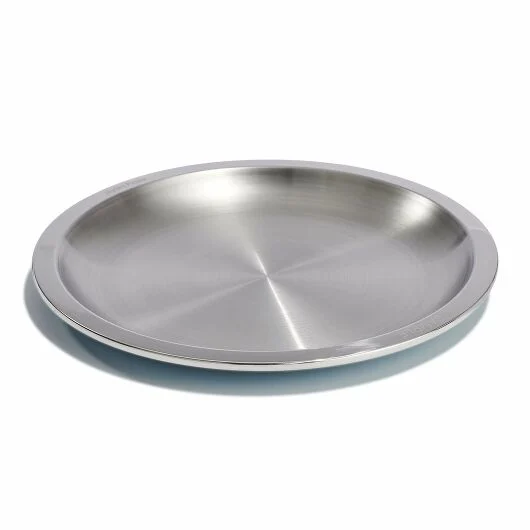 A Hydro Flask Camp Plate, showcasing its durable, stainless steel construction with a matte finish, designed for outdoor use and displayed on a textured surface.