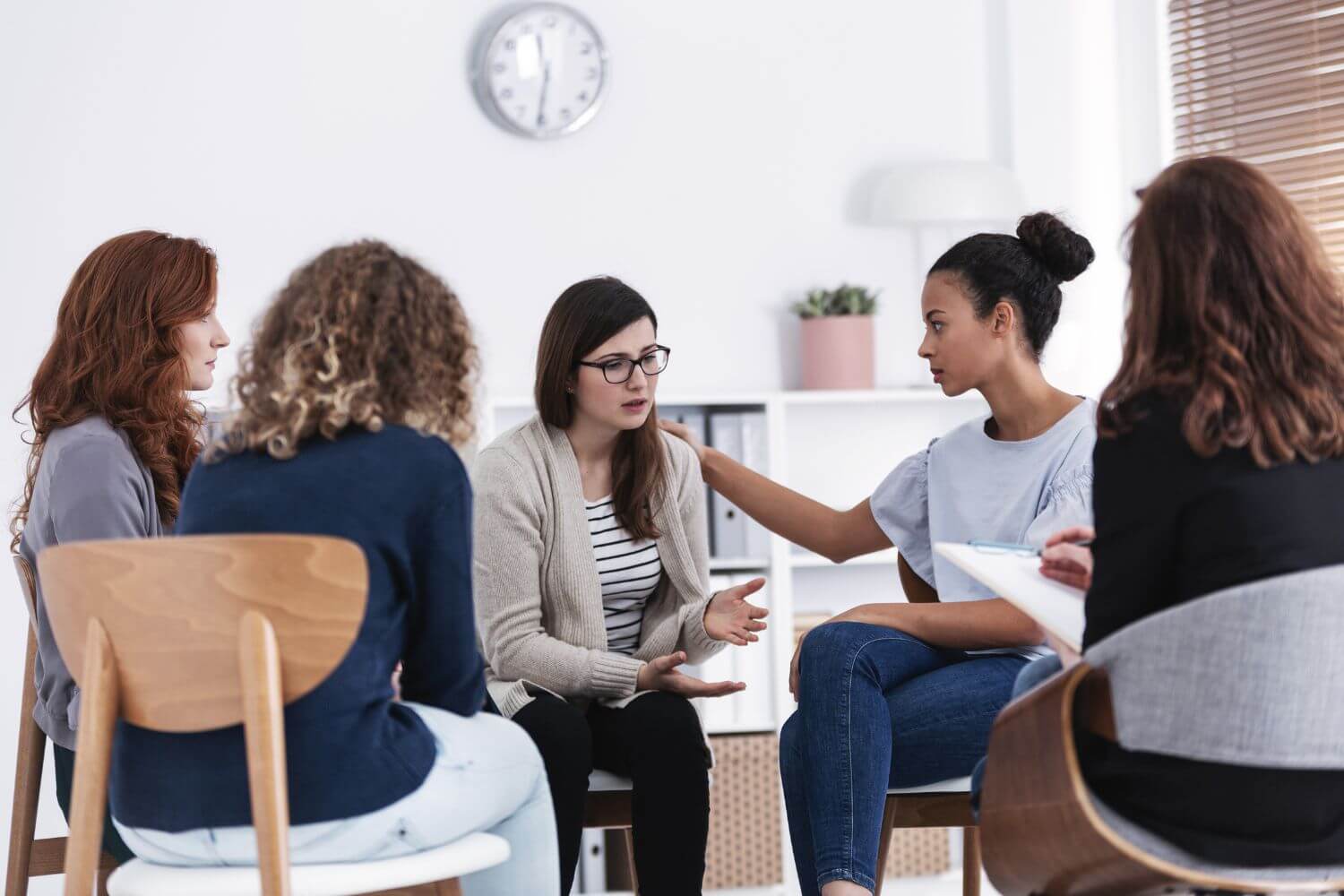 Group of women sitting in a circle having a discussion