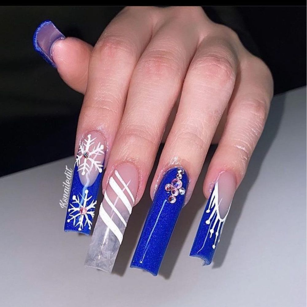 Close up of hands with blue winter nails having  Long French Winter Manicure 