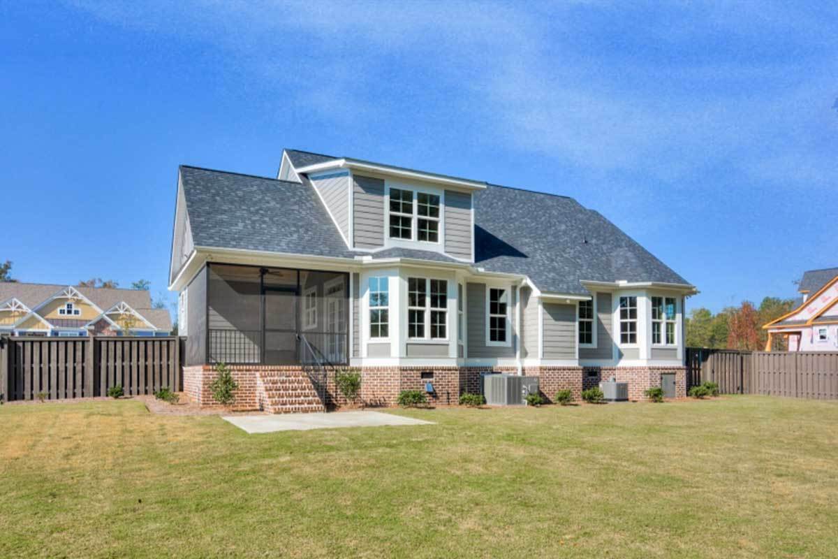 Rear exterior view with screened porch, shed dormer, and bay windows illuminating the breakfast nook and the primary suite.