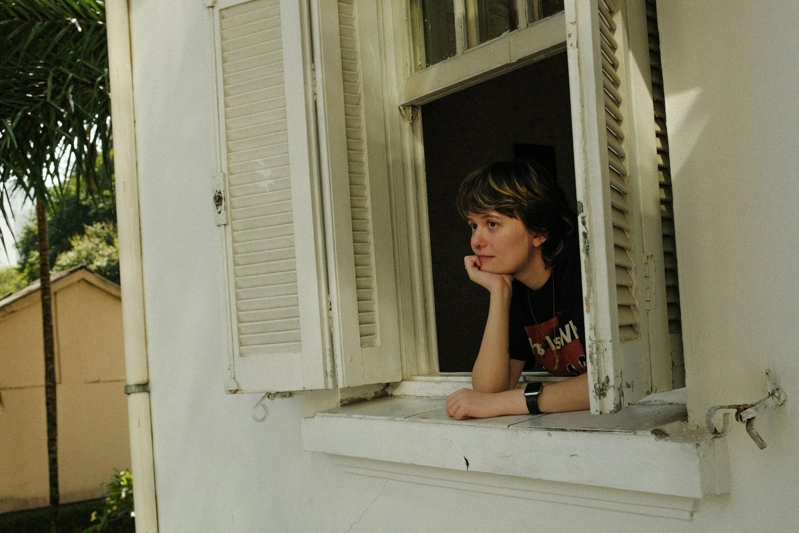 a boy sitting in a window