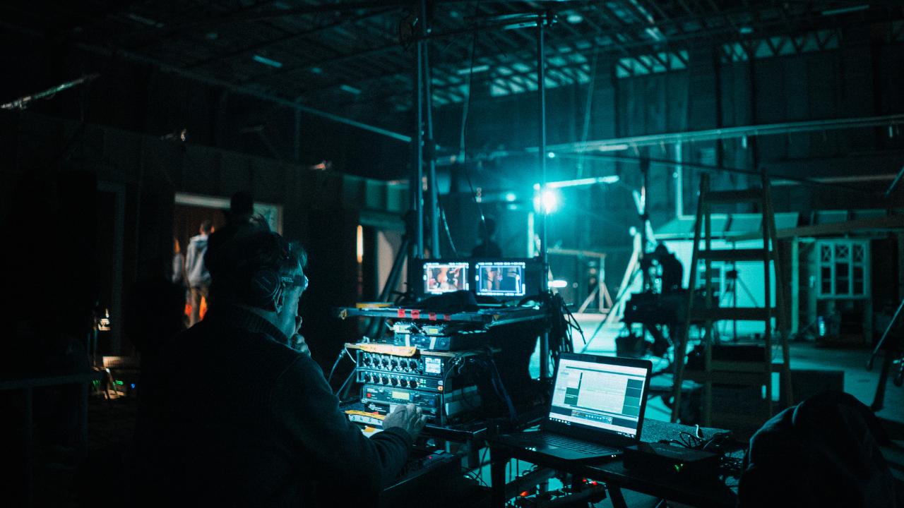 An image of a lighting engineer adjusting the lights on a movie set