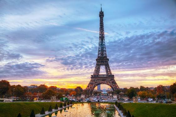 Eiffel Tower with a body of water in front of itDescription automatically generated