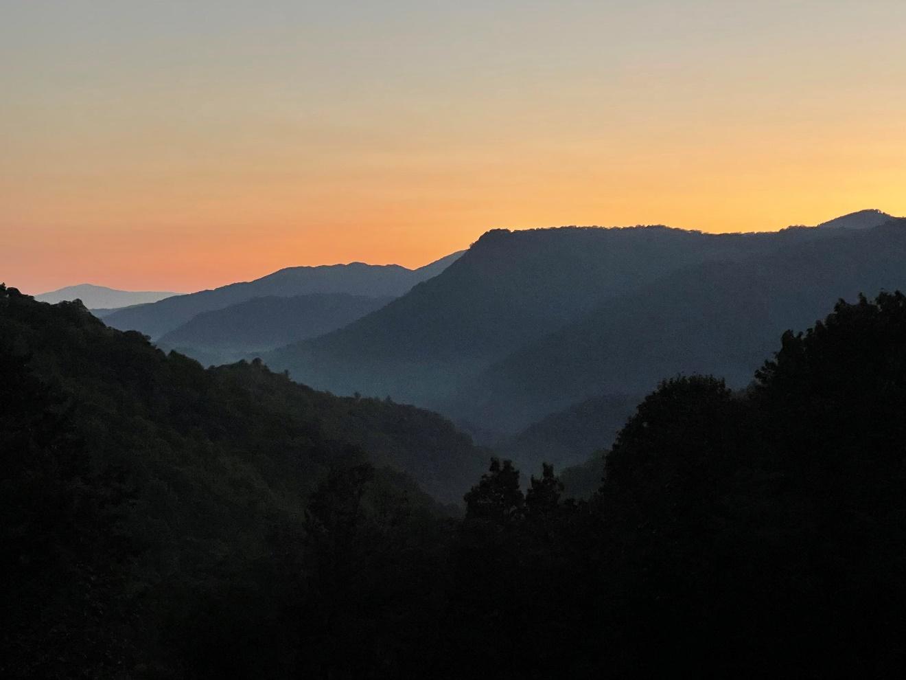 A mountain sunset behind The Cabin at The Retreats at Spring Creek Preserve.