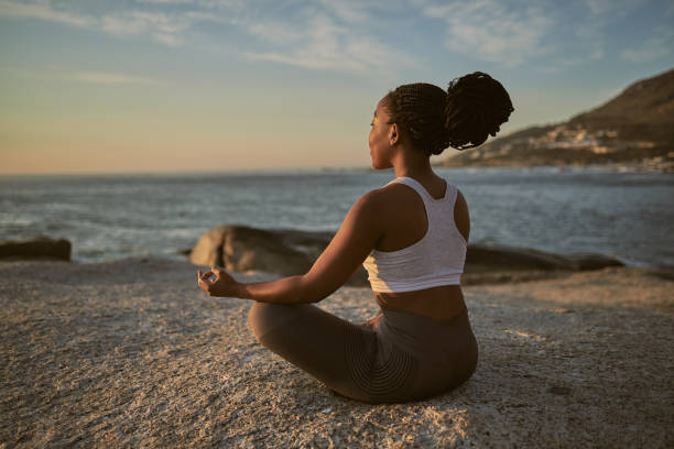 A woman is seen meditating for her mental wellness.