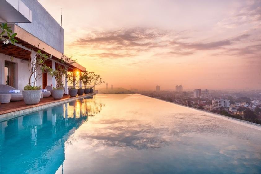 A pool with a rooftop view of a city

Description automatically generated