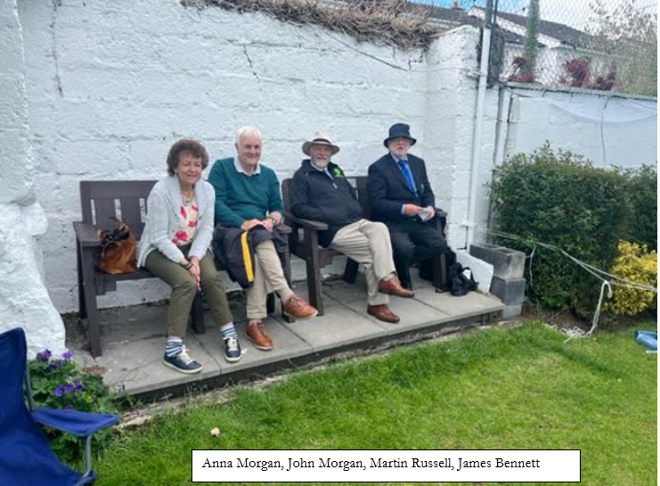 A group of people sitting on a bench

Description automatically generated
