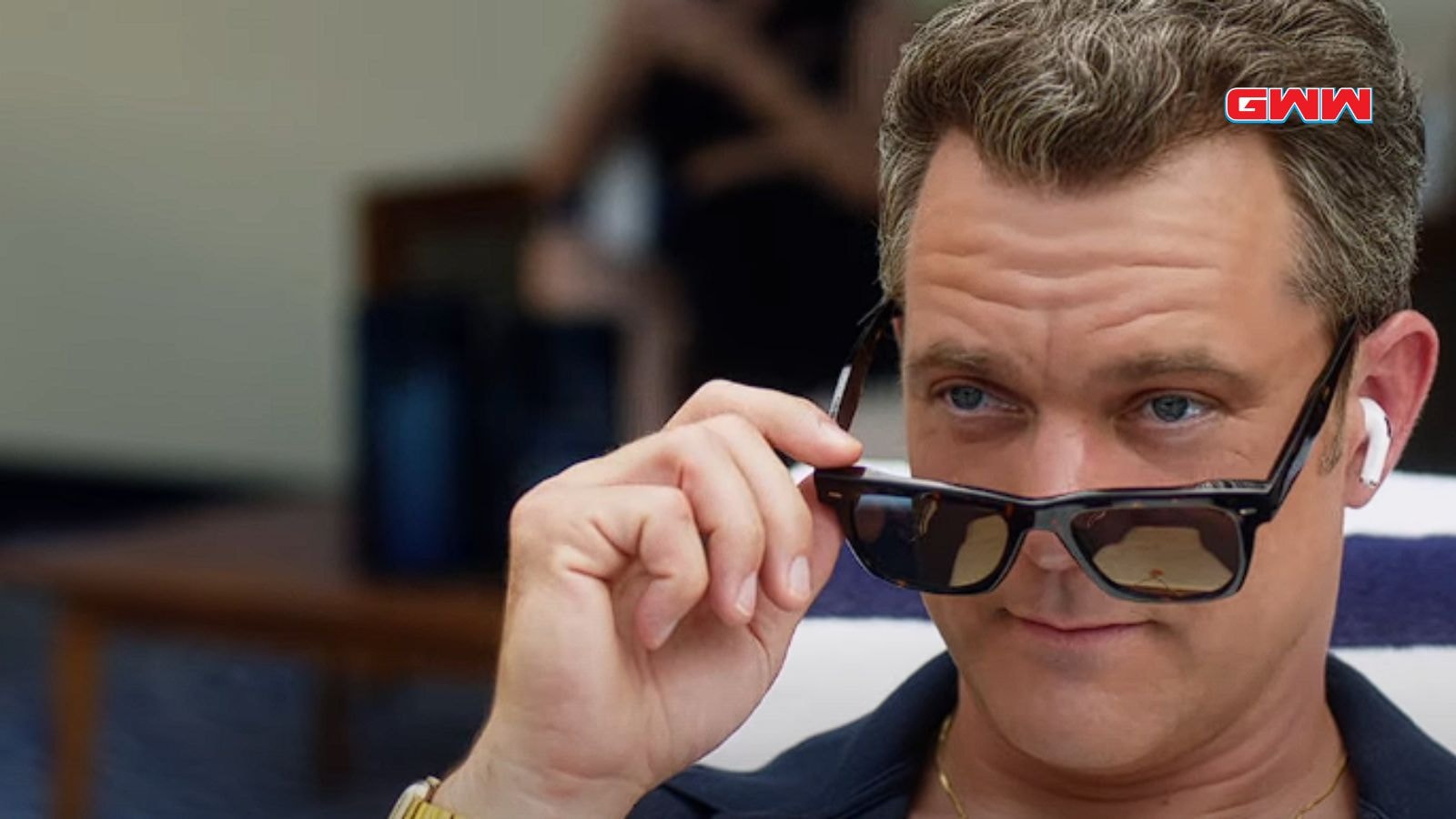 Joshua Jackson adjusting sunglasses on the cruise ship, close-up scene