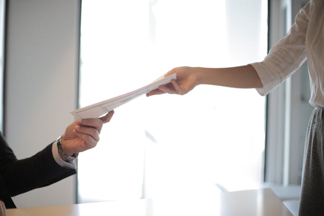 landlord passing paper along