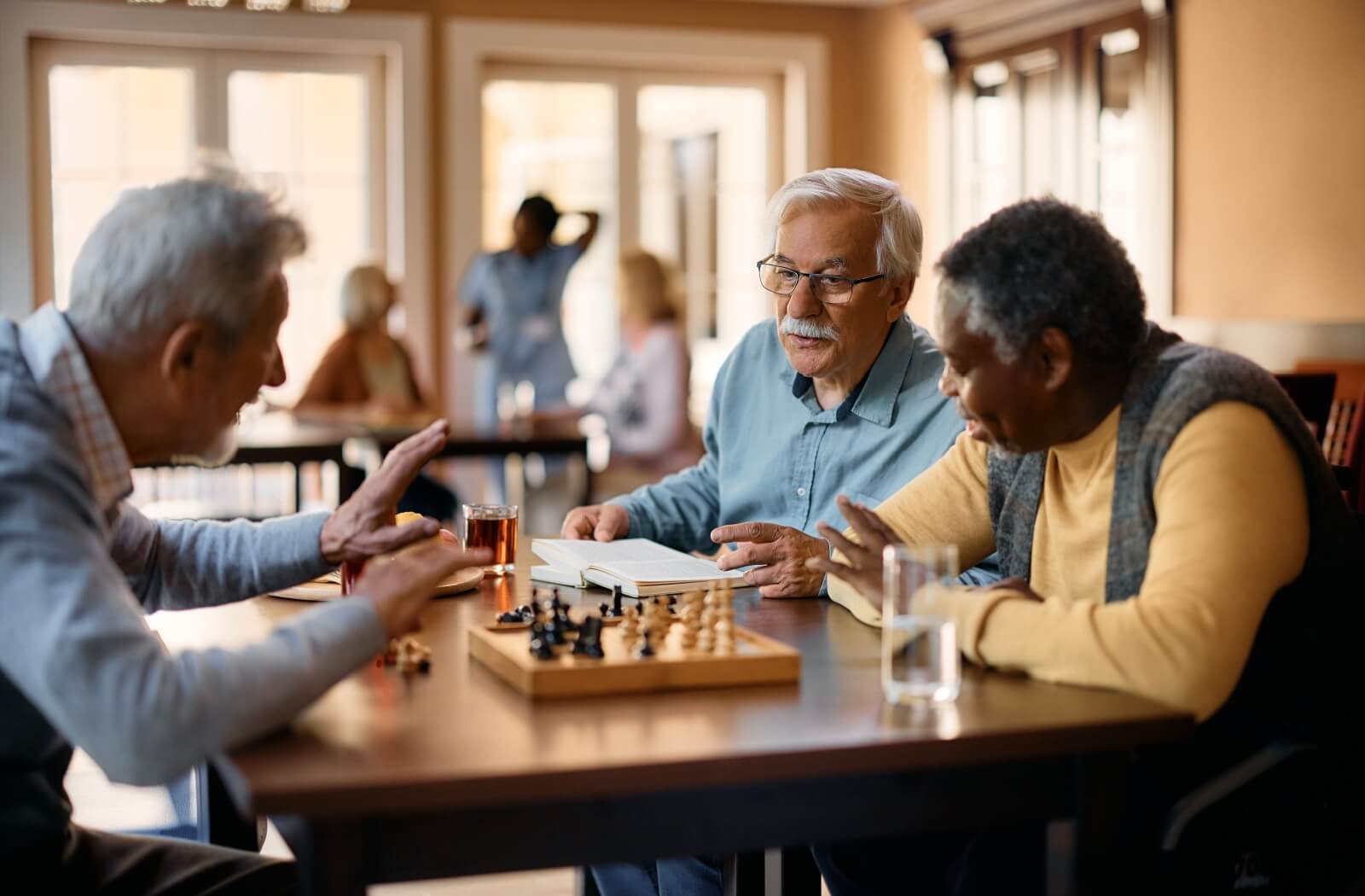 A group of seniors enjoying a game of chess together at a senior living community