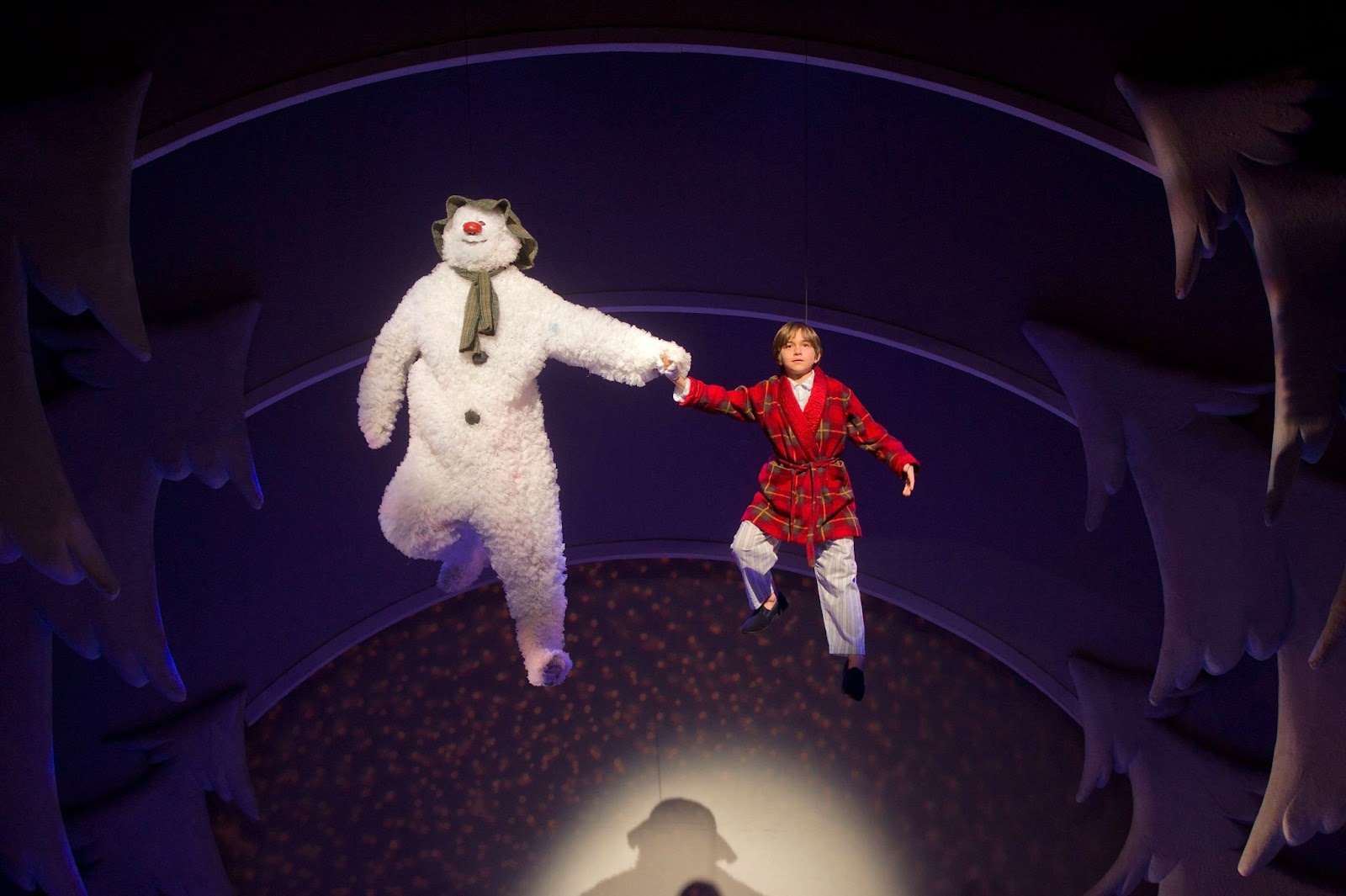 Stage performance of The Snowman at The Peacock Theatre in London, showing the boy and The Snowman under a snowy backdrop