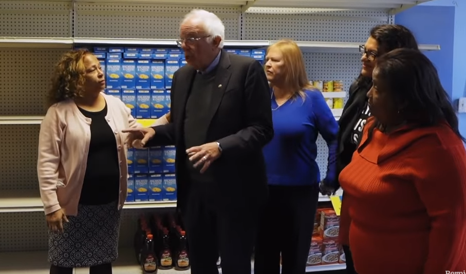 Rashida leads Bernie and Jane Sanders through the Brightmoor Food Pantry