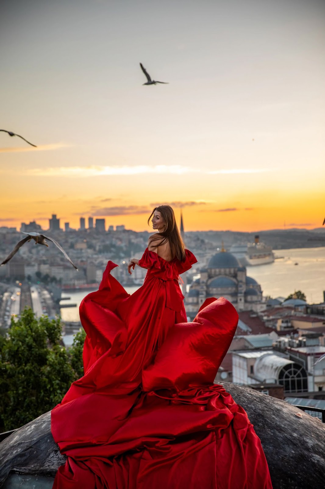 Flaunting on rooftop at sunset, city and sea below