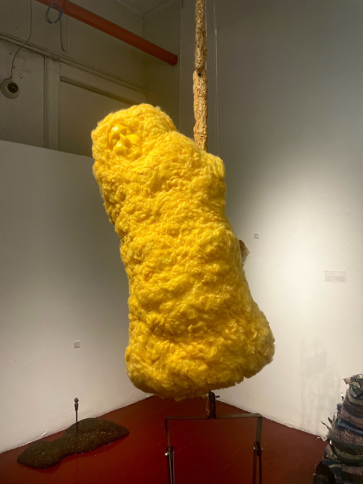 Yellow sculpture with a facial outline. 
