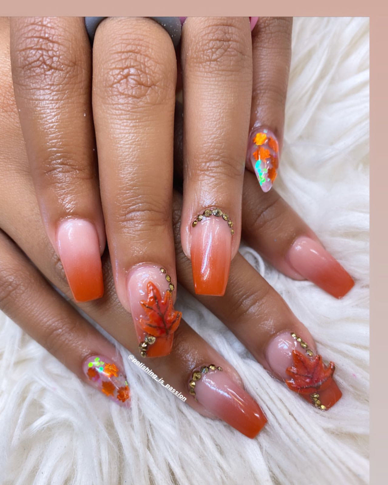 Close-up of hands with fall nail design having 3D Leaf Appliqués