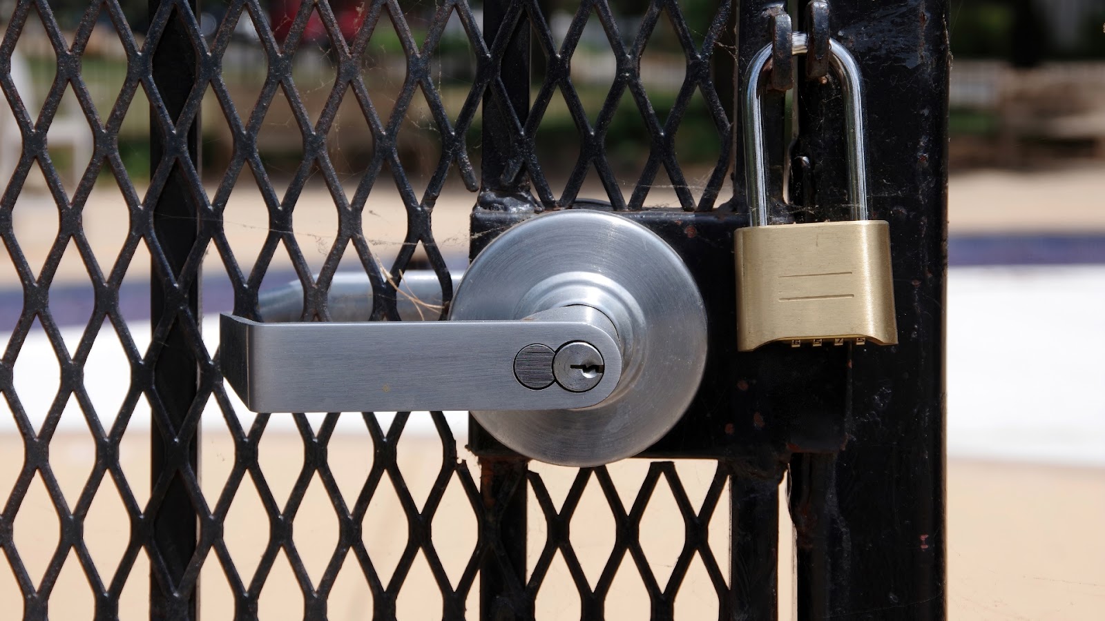 Gate security showing dual lock with lever handle and padlock system