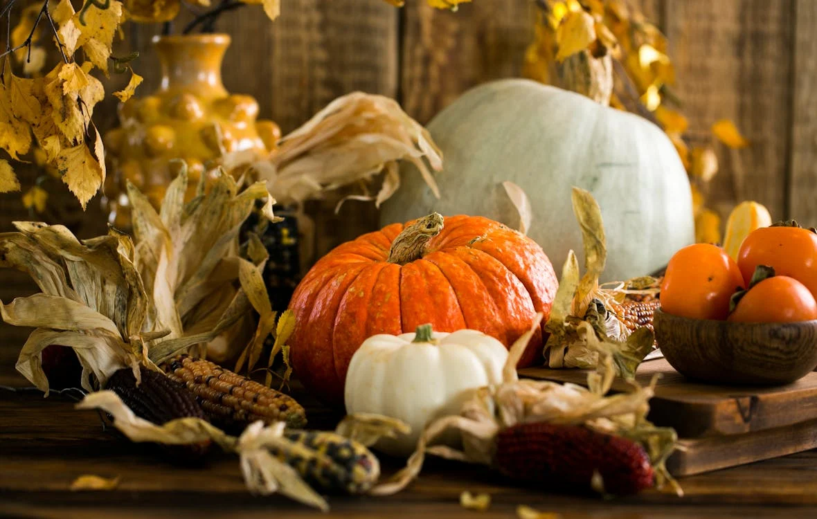 fall themed centerpiece with fake corn and fake pumpkins