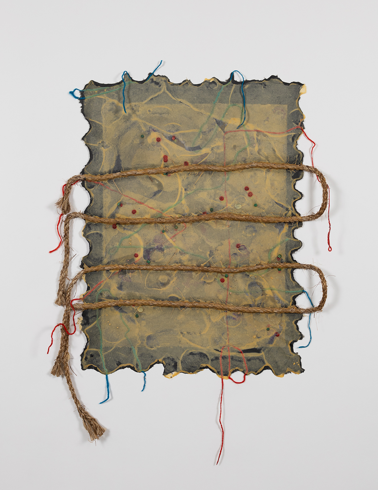 Image: This framed paperwork is "Mawala" by Crystal Z Campbell, 2024. Handmade abaca paper, manila rope, and mixed materials, created in collaboration with Tatiana Ginsberg at Dieu Donné. An abstract rectangular work with jagged edges and a rope twisted around it. Photo by Tejan Rahim. Courtesy of Dieu Donné and Crystal Z Campbell.