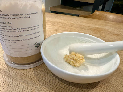 A spoonful of miso in a mortar