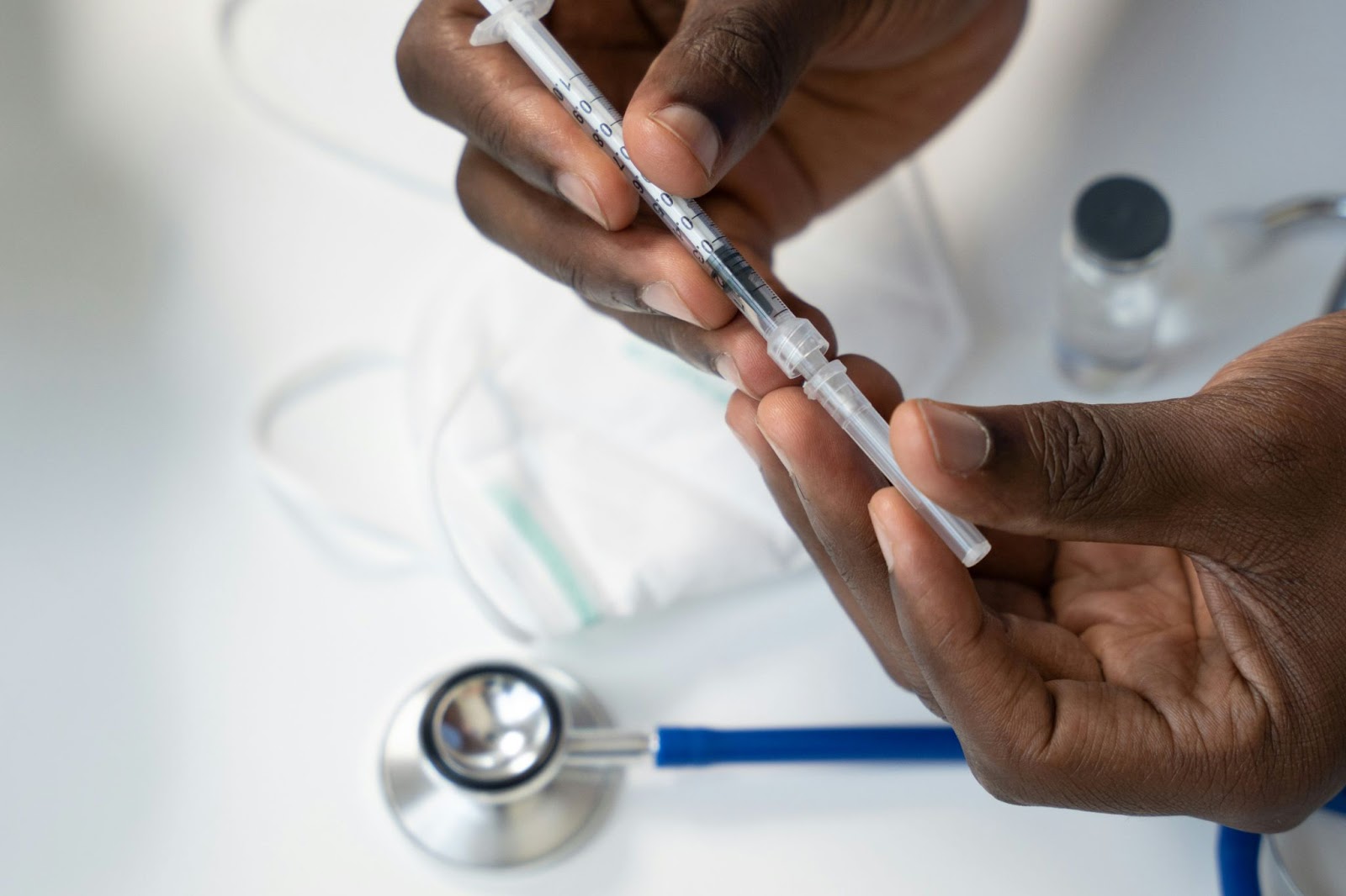 Man holding a sterile syringe