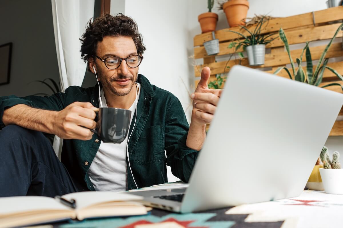 Employee drinking a cup of coffee while working