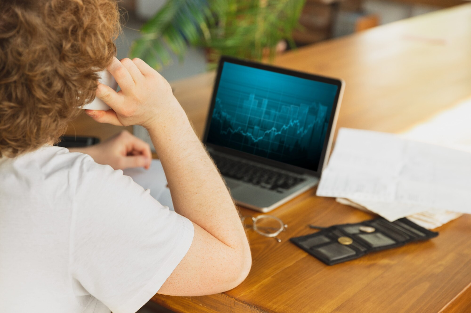  a person engaged in work or financial analysis, cryptocurrency trading, or stock market activity in a relaxed but professional setting.