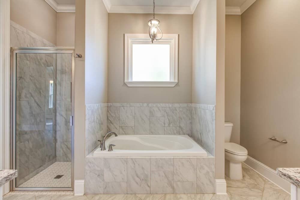 A walk-in shower, toilet area, and bathtub complete the primary bathroom.