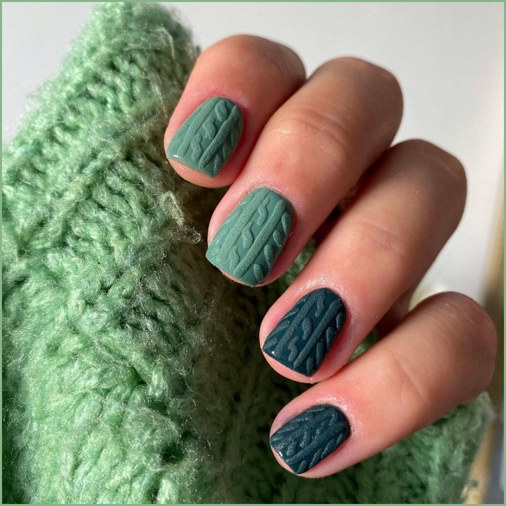 Close up of hands with Christmas Green Nails having  Christmas Cable Knit Design