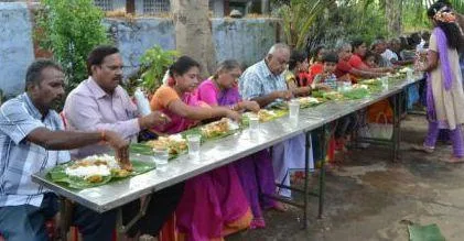 A group of people eating at a long table

Description automatically generated