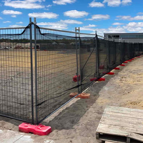 scaff net fencing shade cloth installed on construction temporary fencing.