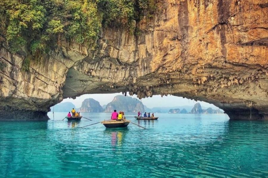 Kayaking through rocky caves eroded by wind and seawater over millions of years