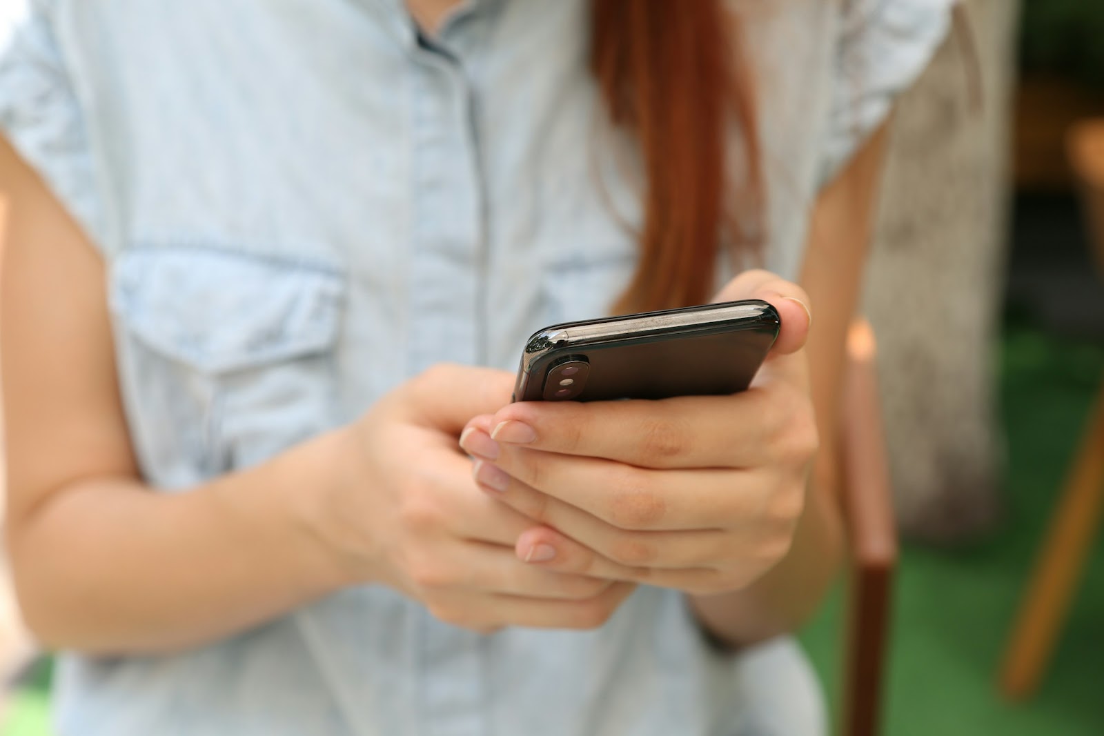 A woman holding a phone | Source: Unsplash