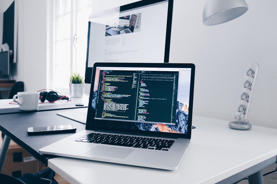 A laptop on a desk with a keyboard and mouse, related to evaluating AI search platform scalability and flexibility.