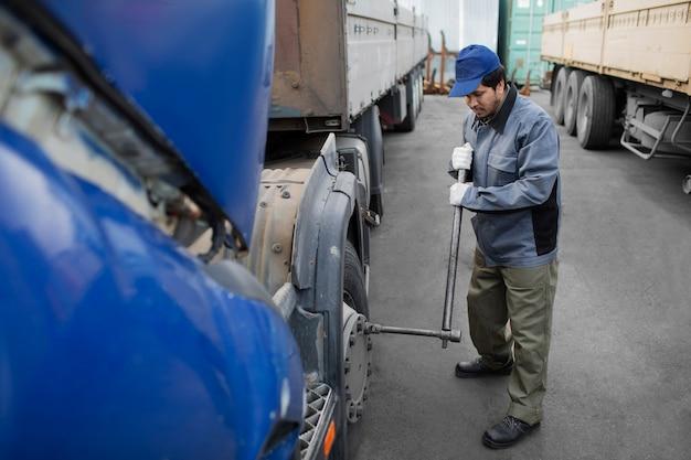 Mechanic checking truck full shot