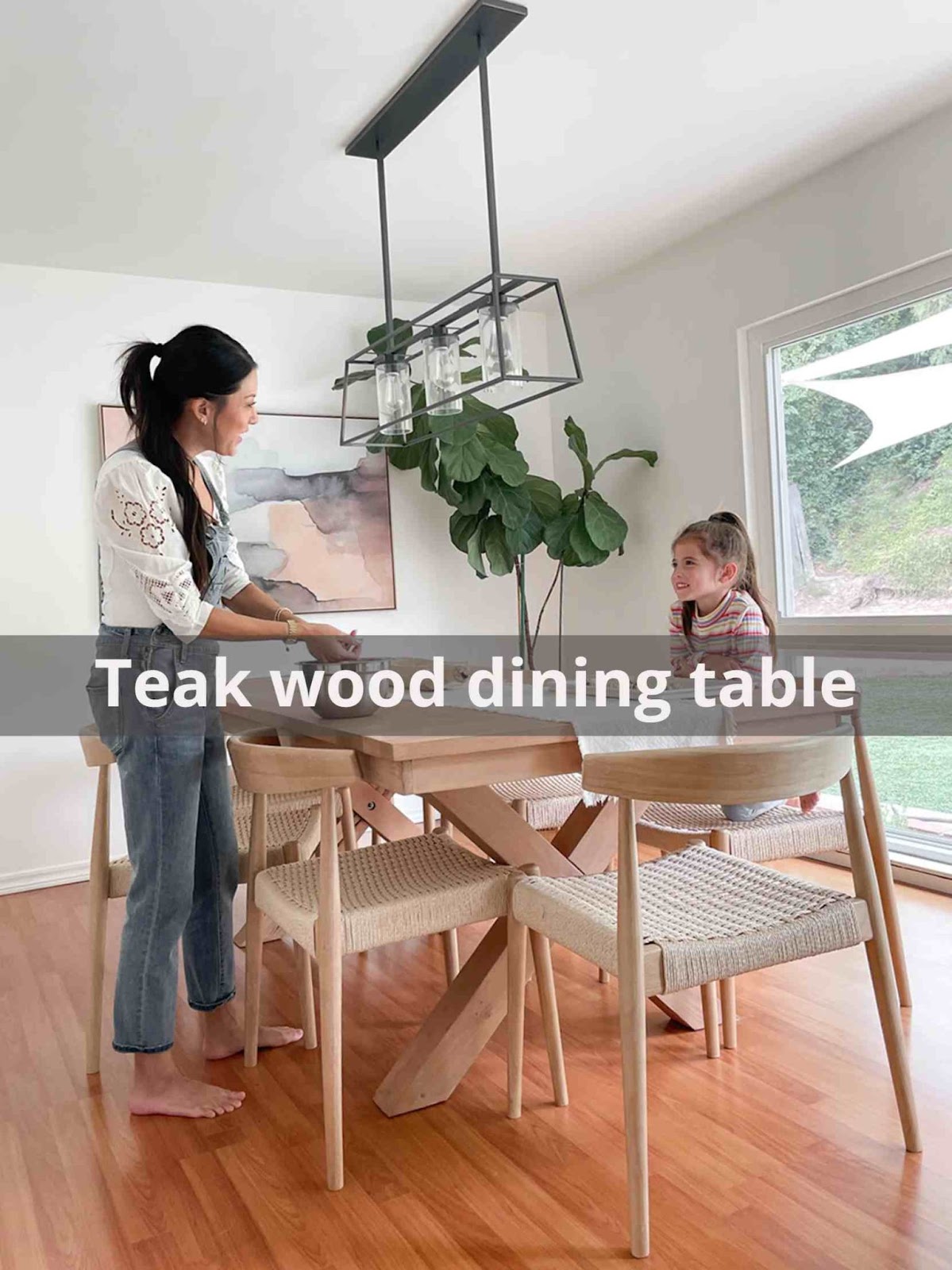 A mother with her daughter around the teak wood dining table