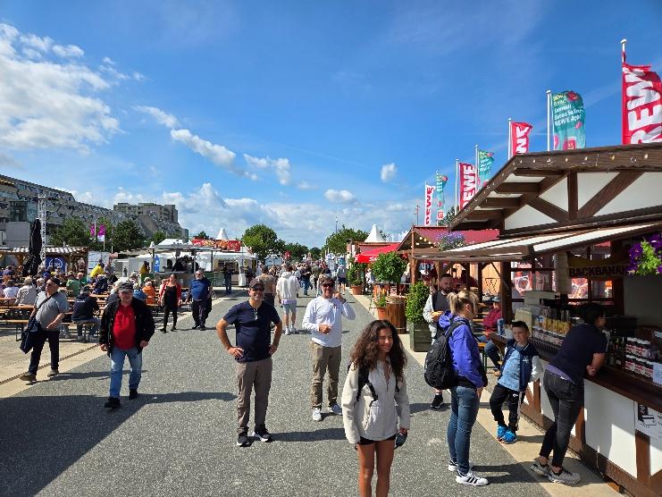 A group of people walking on a street

AI-generated content may be incorrect.