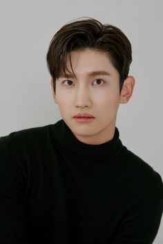 This contain TVXQ's Changmin  is wearing a black turtle neck sweater and looking at the camera with an intense look on his face