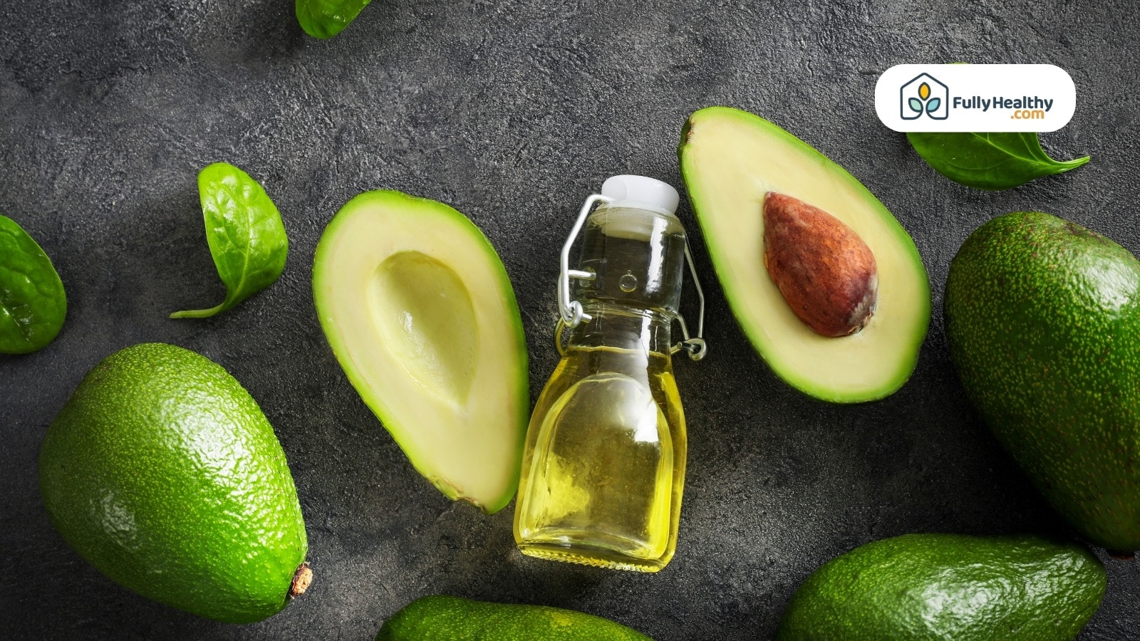 Small glass bottle of avocado oil with whole and halved avocados