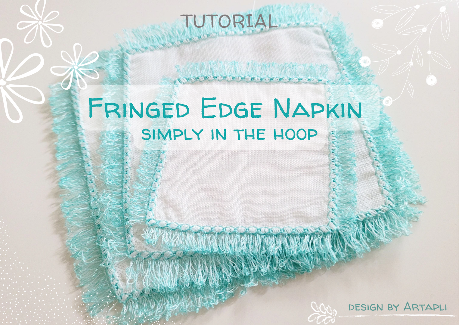 A finished linen napkin with a decorative, machine-embroidered fringed edge.