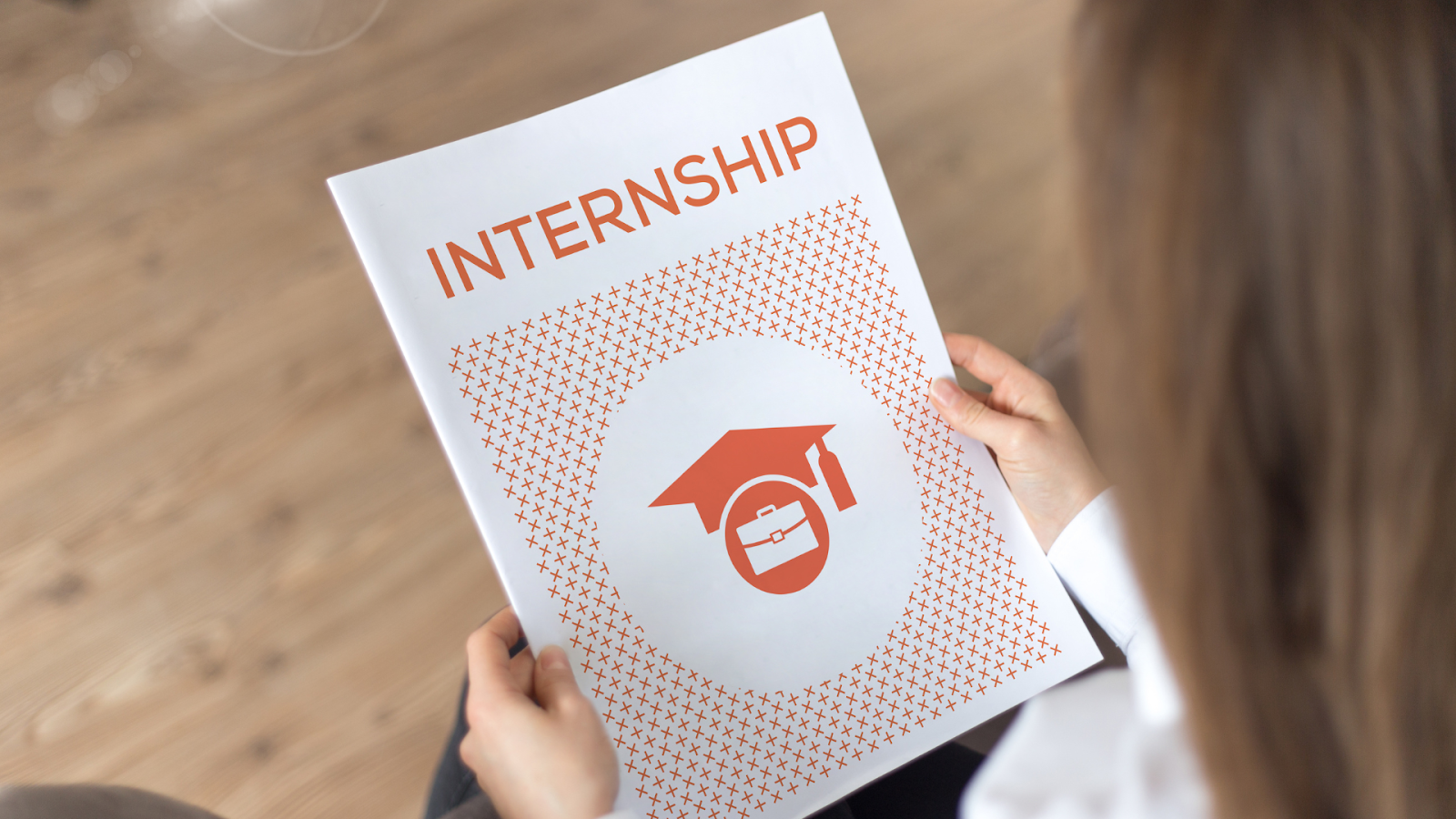 Woman holding a page that says "internship" in bold and in the color red // Healthier Veterans Today