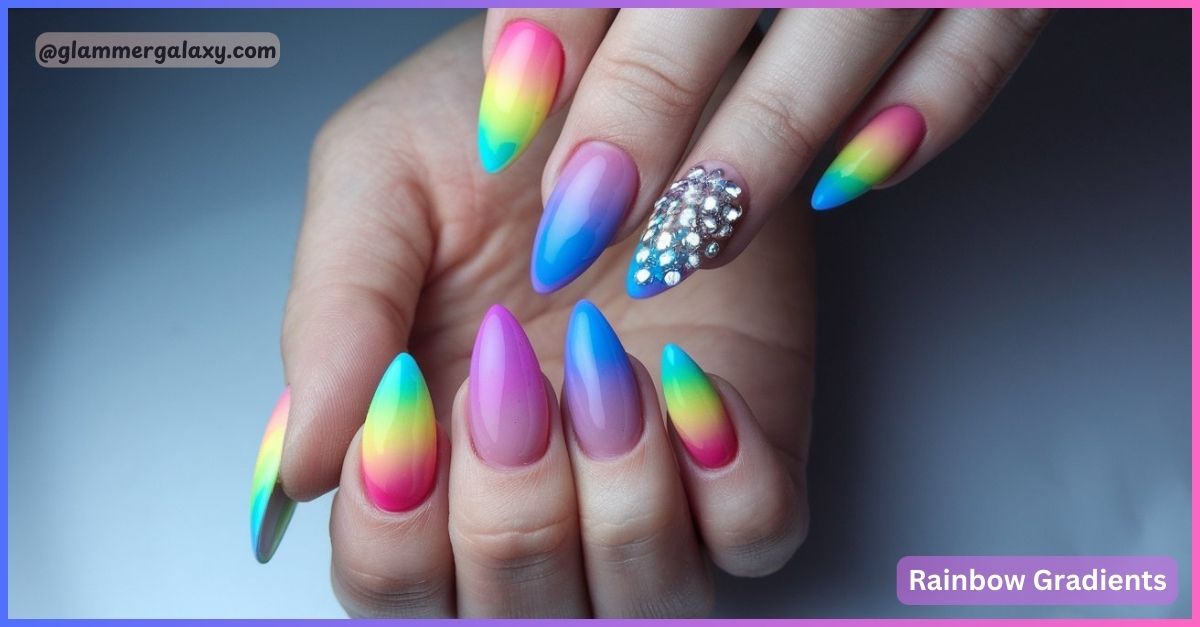 Multicolored gradient manicure on long nails with one accent jeweled nail.