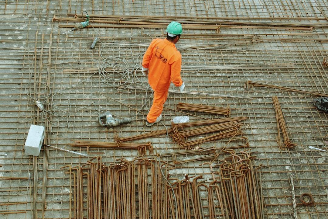 A person in orange jumpsuit standing on a floor<br />
<br />
Description automatically generated