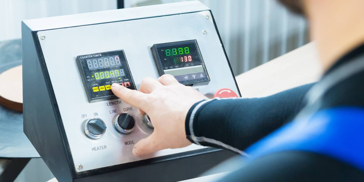 Machine operator managing a digital control panel for precision manufacturing processes.