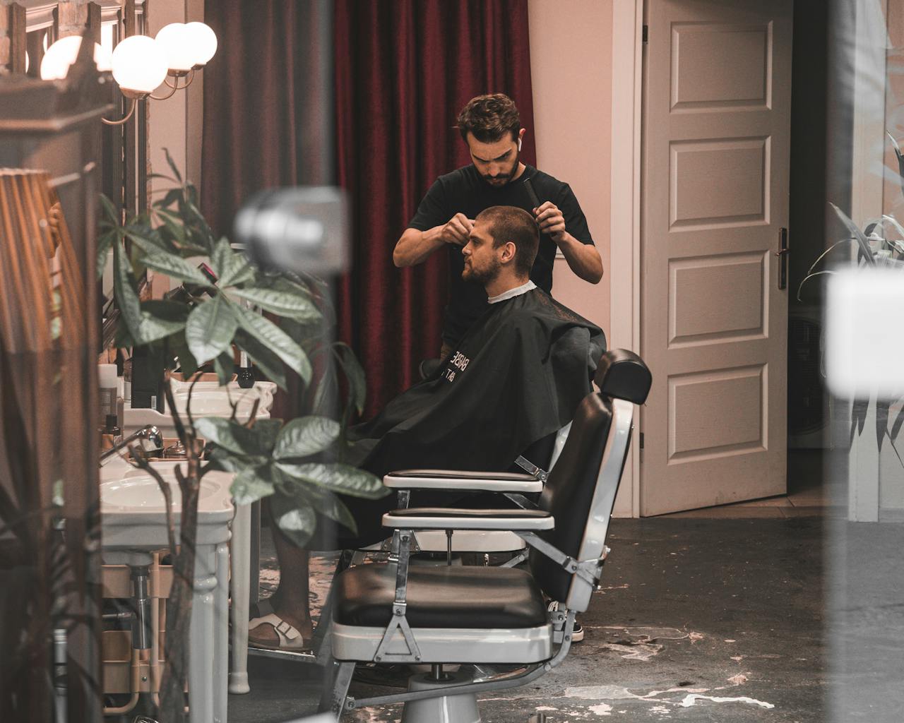 Barber giving a haircut to a client in a modern barbershop