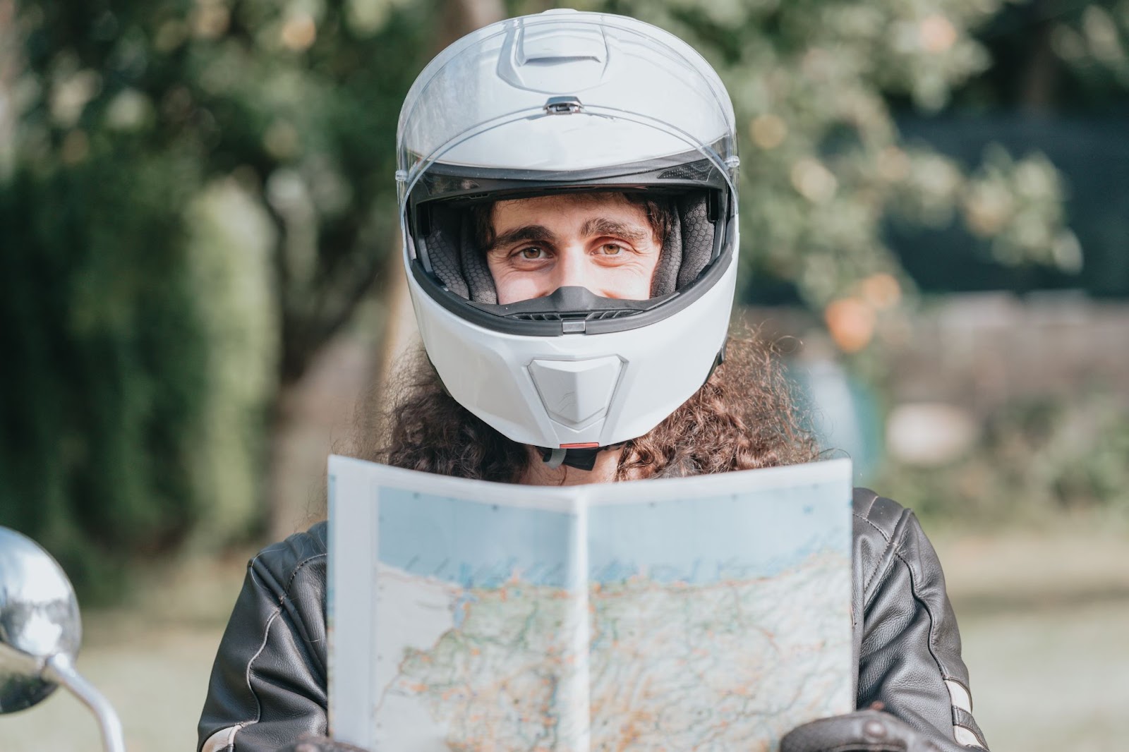 Motorcycle rider holding map used to plan and verify route for Iron Butt ride