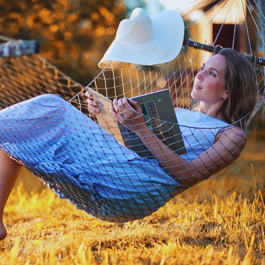 woman reading a book in hammock