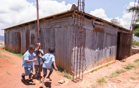 A group of children playing outside a building

Description automatically generated