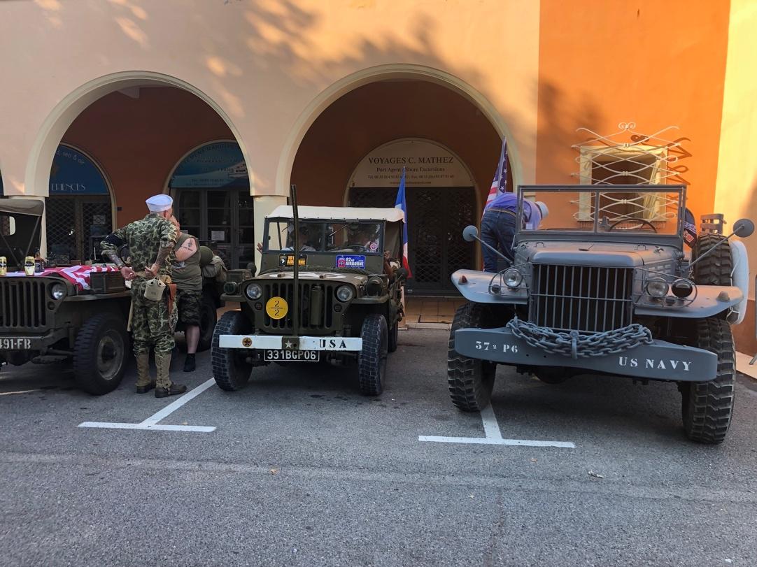 A group of military vehicles parked in front of a building

Description automatically generated