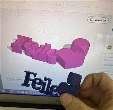 Photo of Tinkcard with 3D desinged key chane and someone holding the 3D Printed keychain.